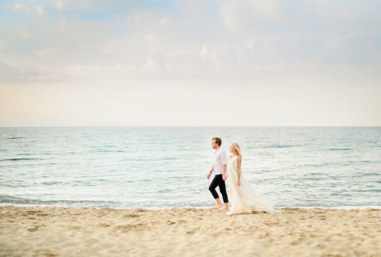 Beautiful stylish couple posing on the beach