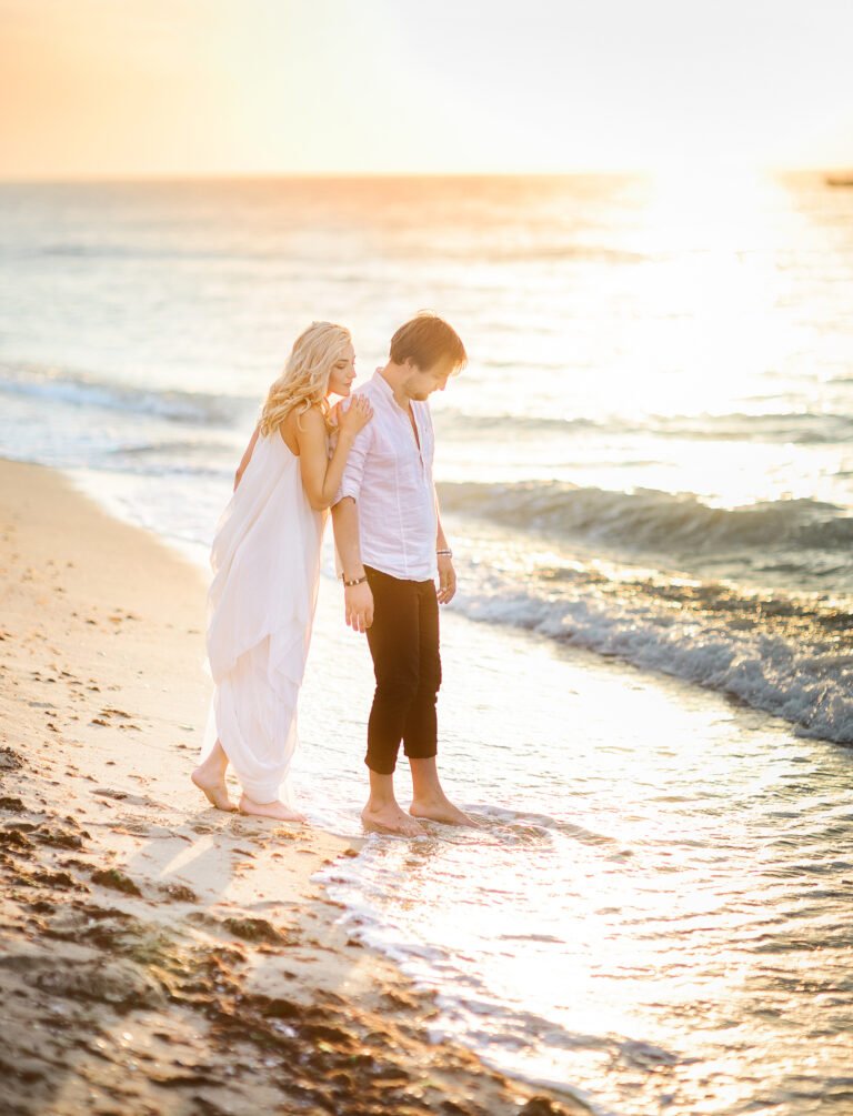 Beautiful stylish couple posing on the beach